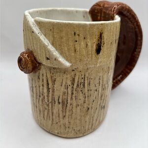 Studio‎ Art Pottery Mug - Signed 
Looks like wood w/ a rose button.